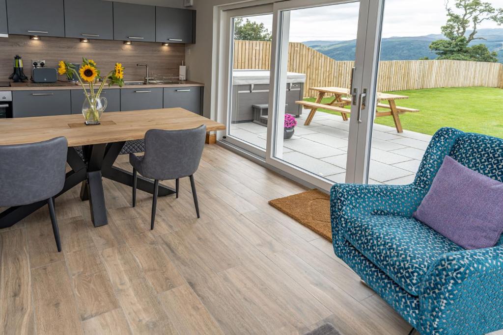 a kitchen and dining room with a table and chairs at The Annexe, Luxury Property with Hot Tub at Pitilie Pods in Aberfeldy