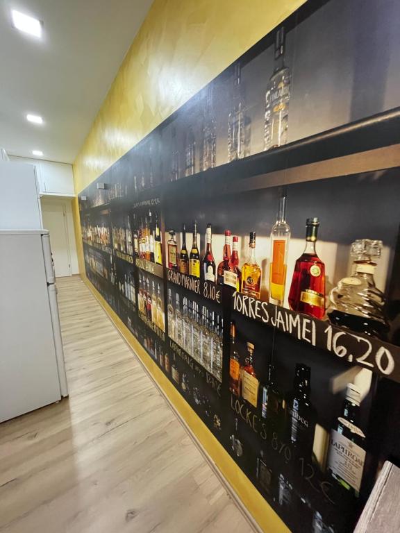 a room with bottles of alcohol on the wall at Joanna Apartment - MA Rheinau in Mannheim