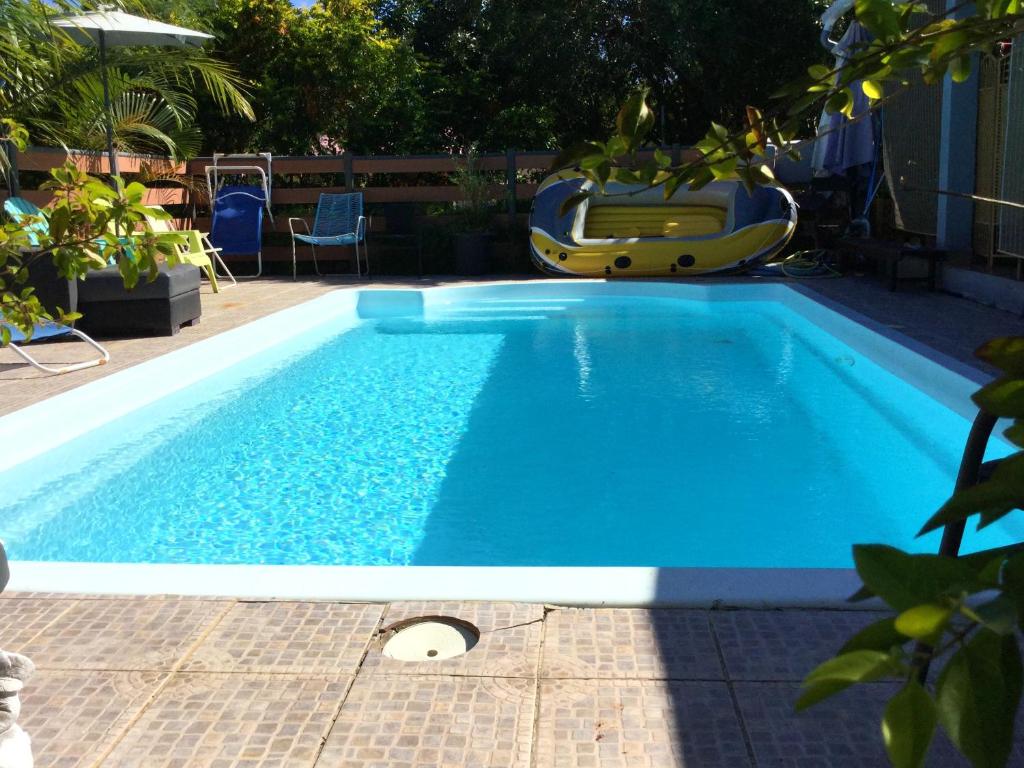 a large blue swimming pool with a slide at Villa de 4 chambres avec piscine partagee terrasse amenagee et wifi a Le Tampon in Le Tampon