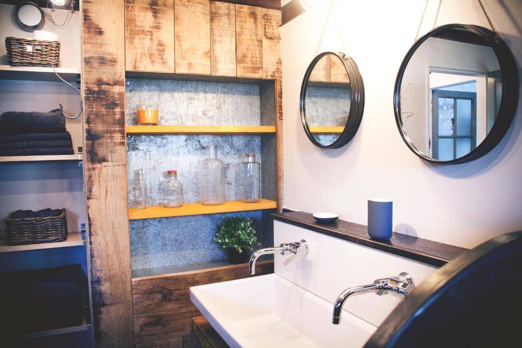 a bathroom with a sink and two mirrors at Chambres d&#39;hôtes de charme - Gîtes cosy - LA CLE DES CHAMPS - A la campagne in Martigné-Ferchaud