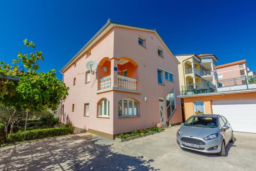 a car parked in front of a house at Apartments Marissimo in Crikvenica