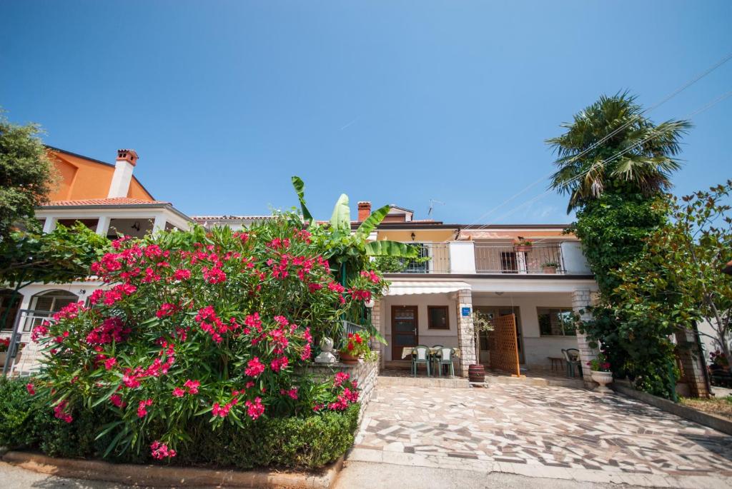 a house with pink flowers in front of it at Haus Roko in Rovinj