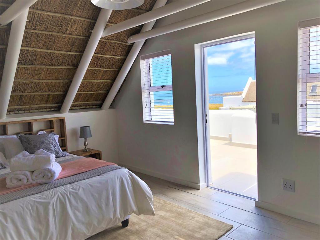 a bedroom with a bed with a view of the ocean at West Coast Shores in Jacobs Bay