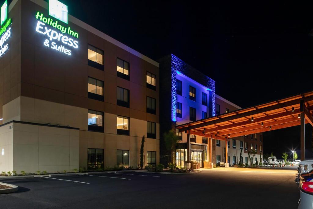 a hotel with a lit up sign in a parking lot at Holiday Inn Express & Suites - The Dalles, an IHG Hotel in The Dalles