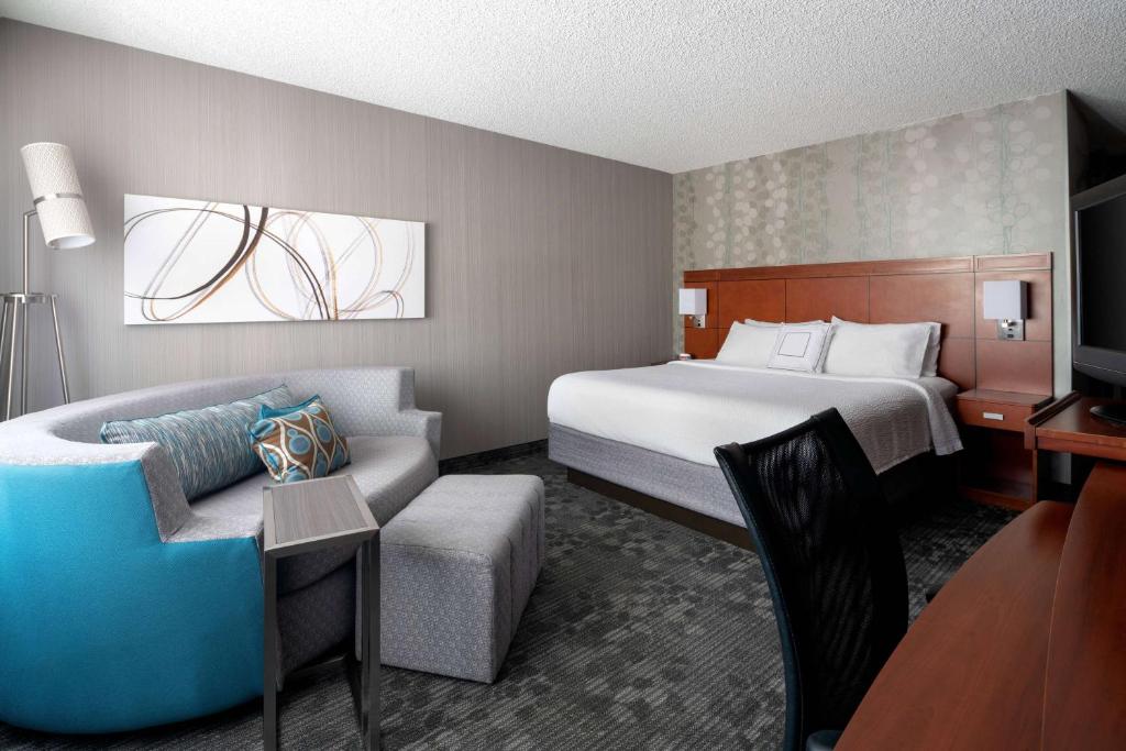 a hotel room with a bed and a couch at Sonesta Select Camarillo in Camarillo