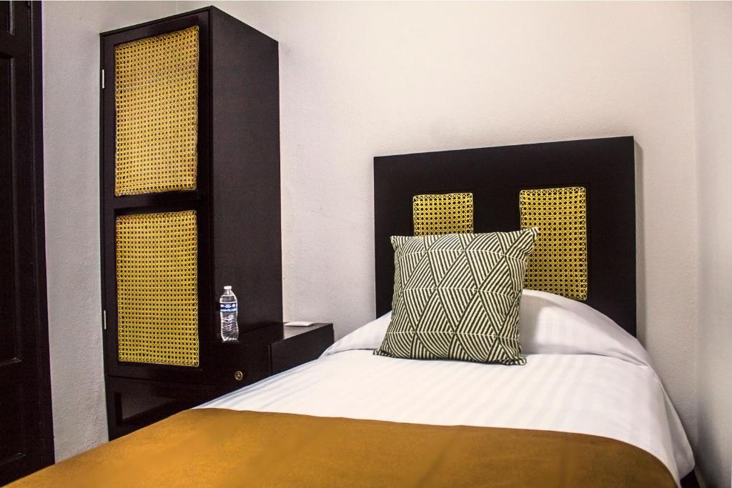 Postel nebo postele na pokoji v ubytování Múcara hotel