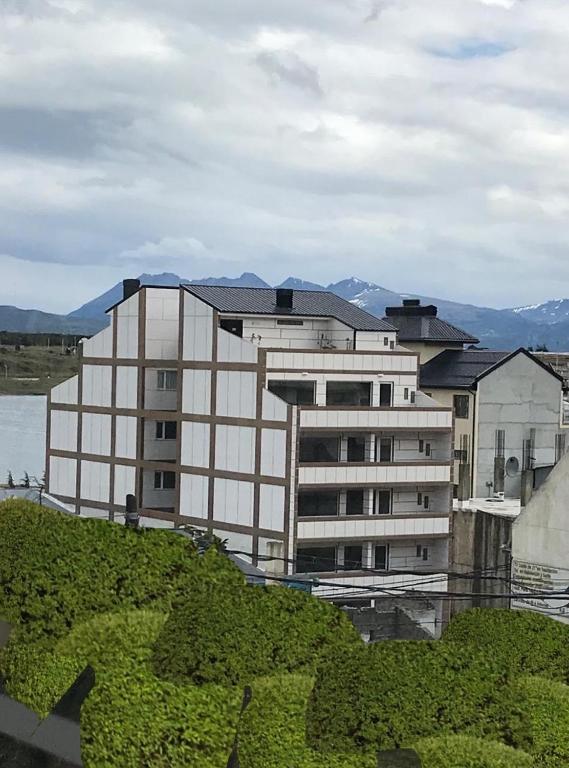 a large building in front of a body of water at ABC DEPARTAMENTOS in Ushuaia