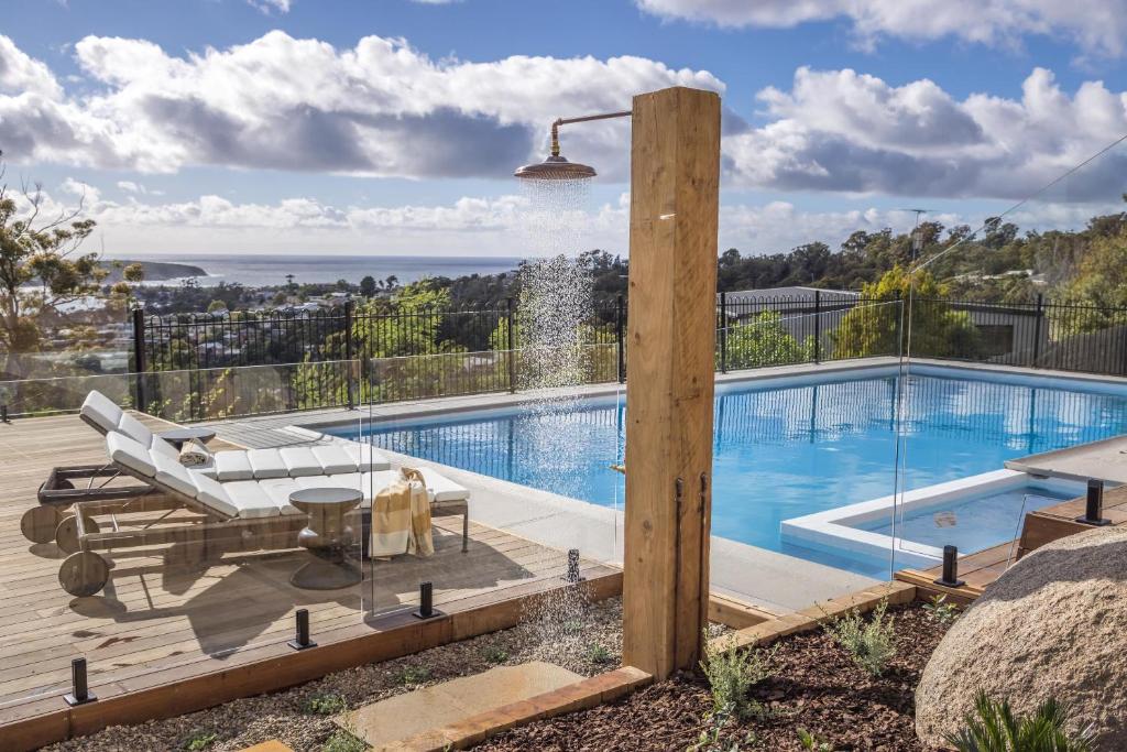 a pool with a view of the ocean from a house at Hillcrest Merimbula in Merimbula