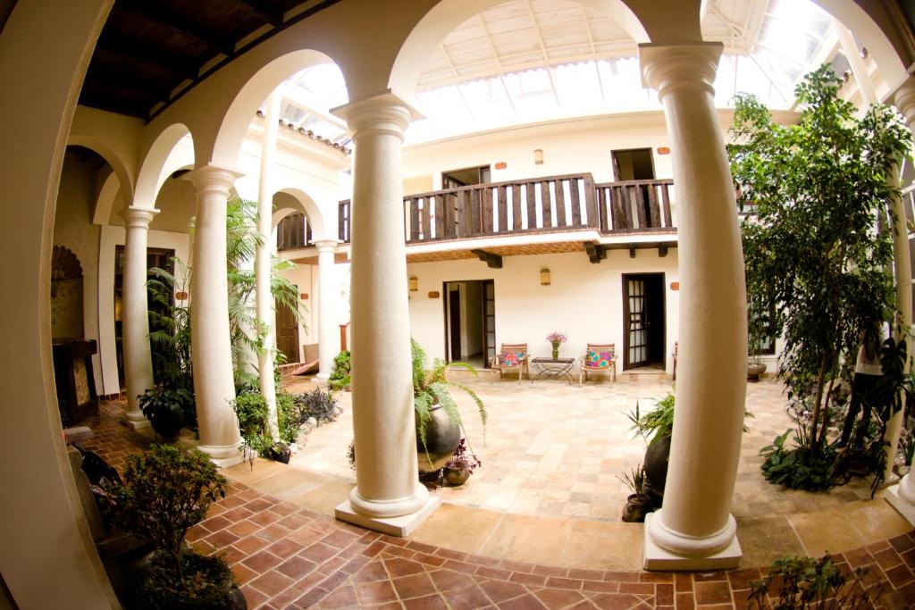 a large stone building with a large window at Hotel Casa Selah in San Cristóbal de Las Casas