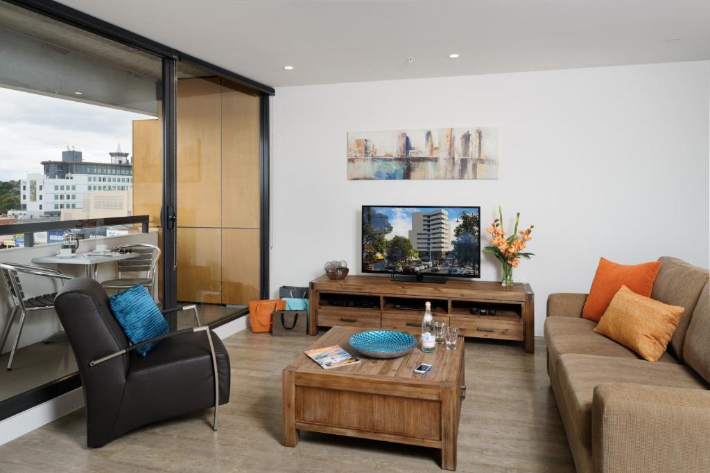 a living room with a couch and a table at Park Avenue - IKON Glen Waverley in Glen Waverley