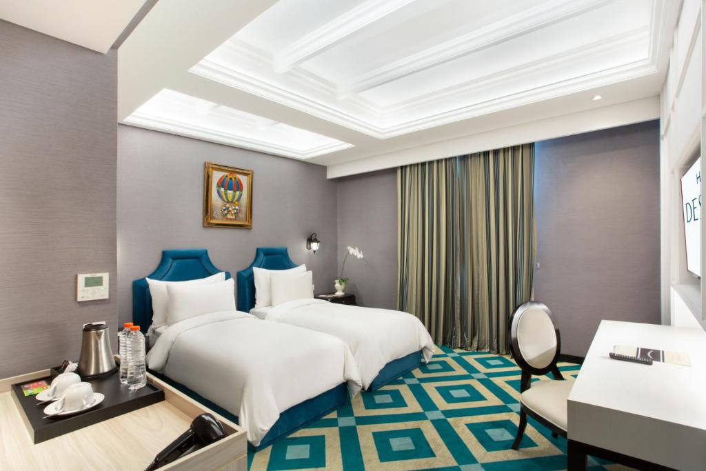 Postel nebo postele na pokoji v ubytování Hotel Des Indes Menteng