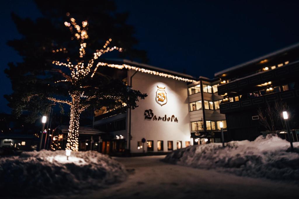 a building with a christmas tree in front of it at Bard&oslash;la Fjelltun in Geilo