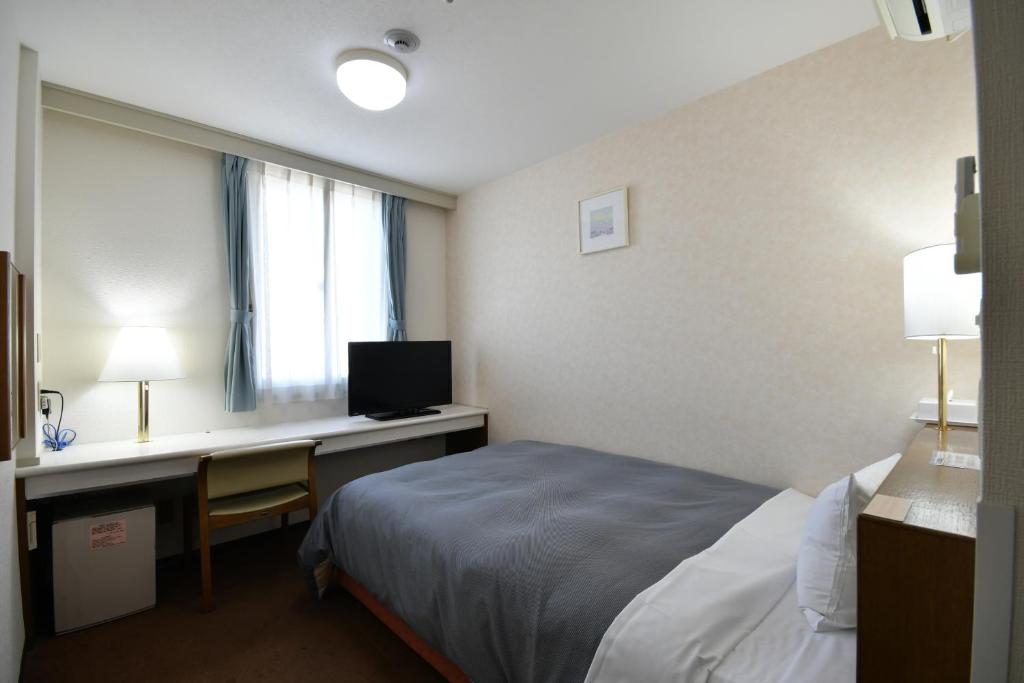 Postel nebo postele na pokoji v ubytování Bell's Inn Tsuchiura