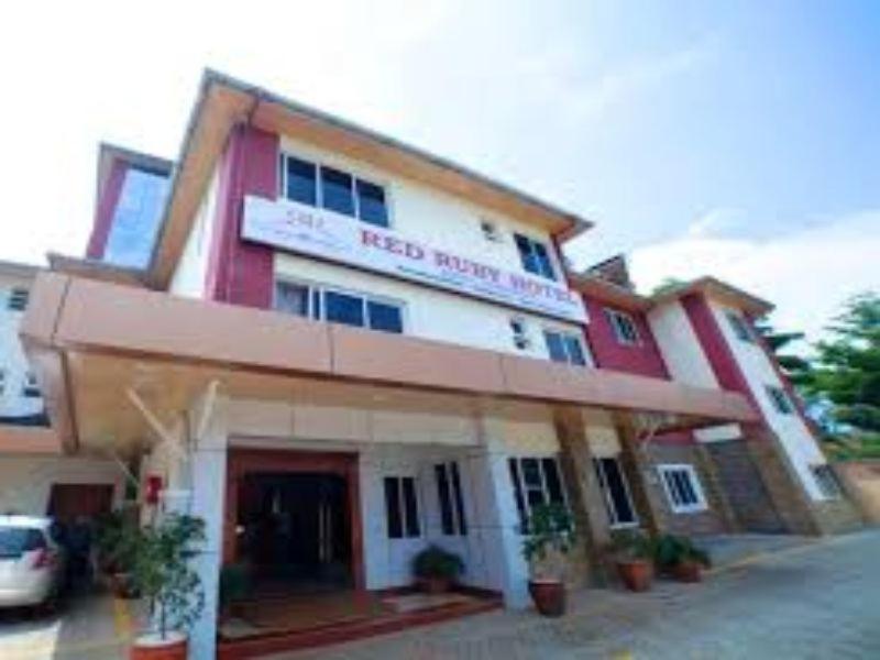 a hotel building with a car parked in front of it at Red Ruby Hotel in Nairobi