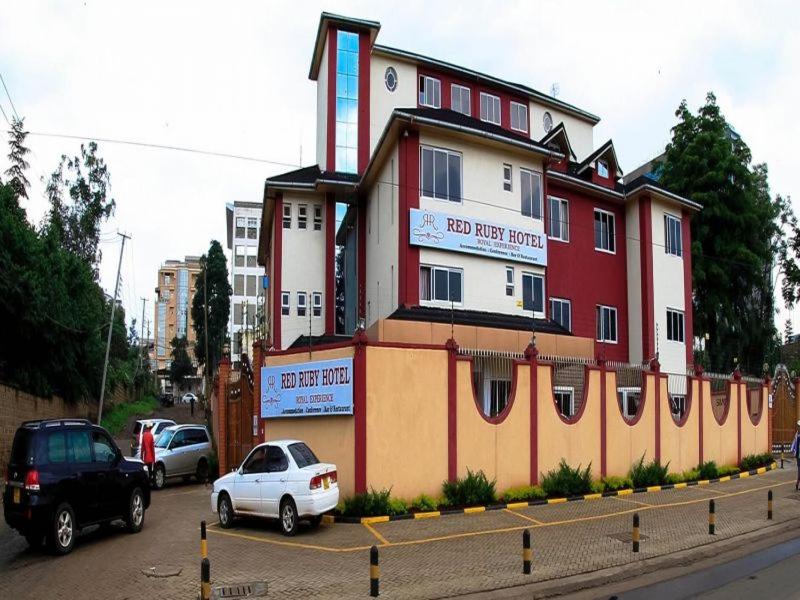 a building with a car parked in front of it at Red Ruby Hotel in Nairobi