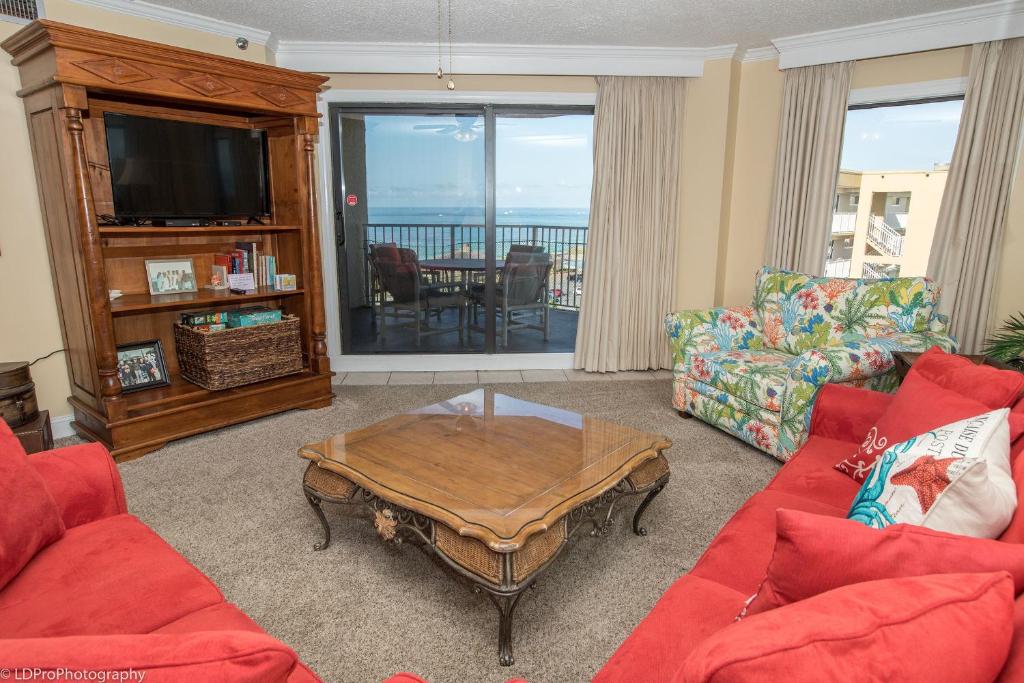a living room with a red couch and a coffee table at Inlet Reef 616 Destin Condo in Destin