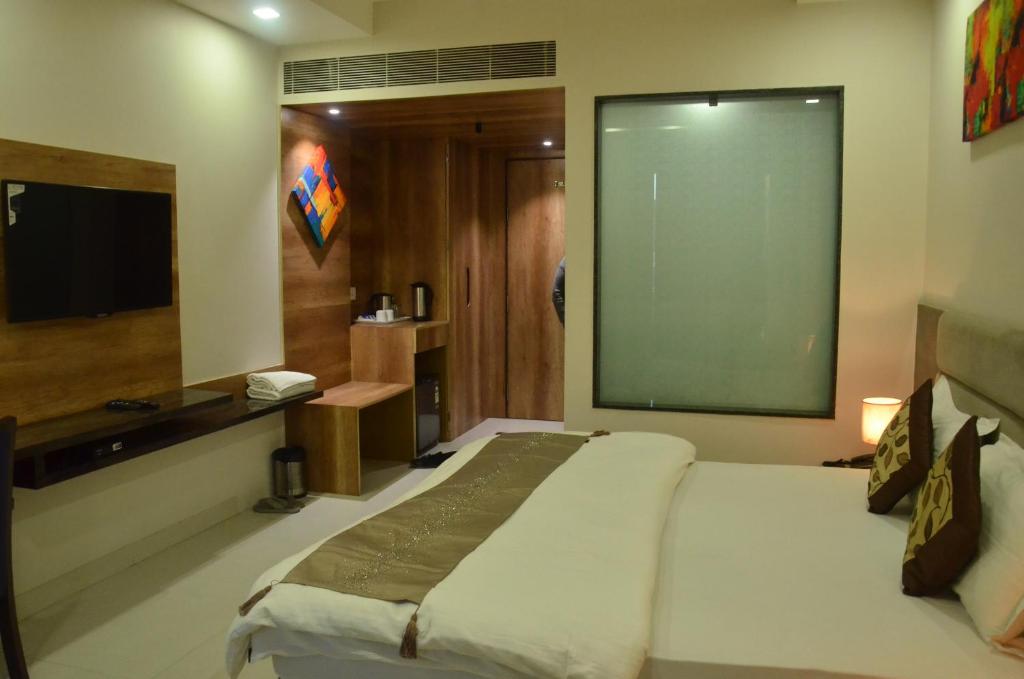 Postel nebo postele na pokoji v ubytování Hotel Sopan Heights