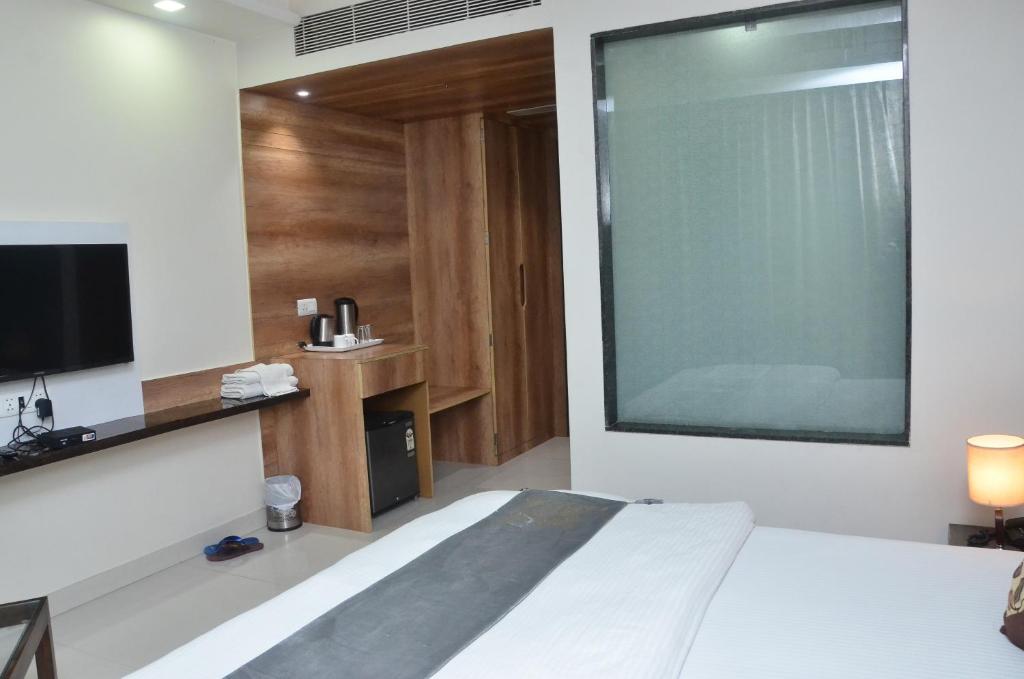 Postel nebo postele na pokoji v ubytování Hotel Sopan Heights