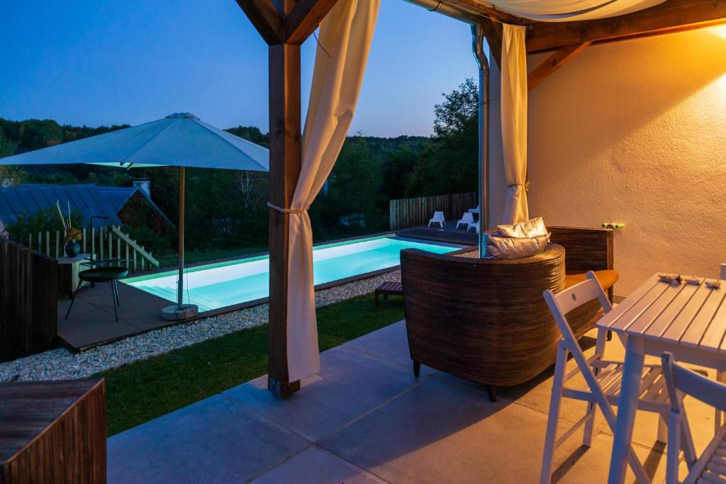 a patio with a swimming pool and an umbrella at GORIČKE IŽE in Križevci