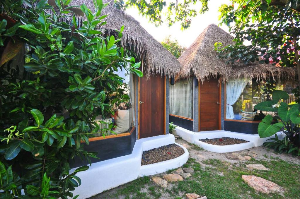 a small house with a window in a garden at Cafe'@luv22 in Phuket Town