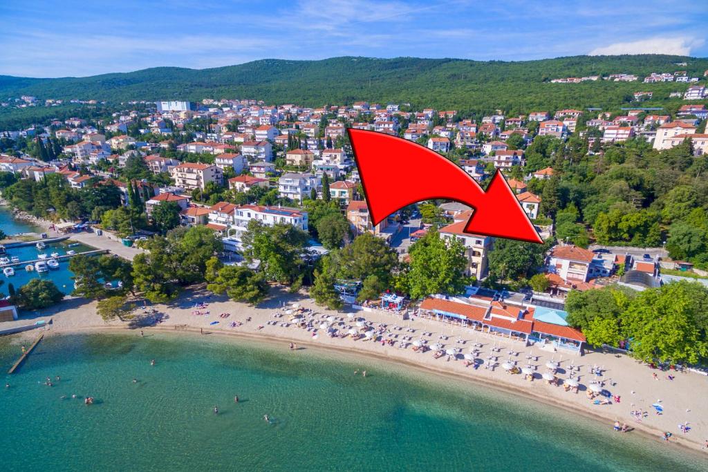 an aerial view of a beach with a red arrow at Roni in Crikvenica