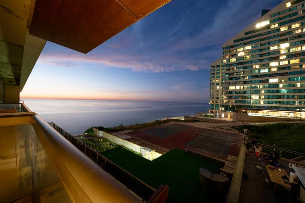 a view of a building with a tennis court at Beachfront Boutique Apartment in Herzliya