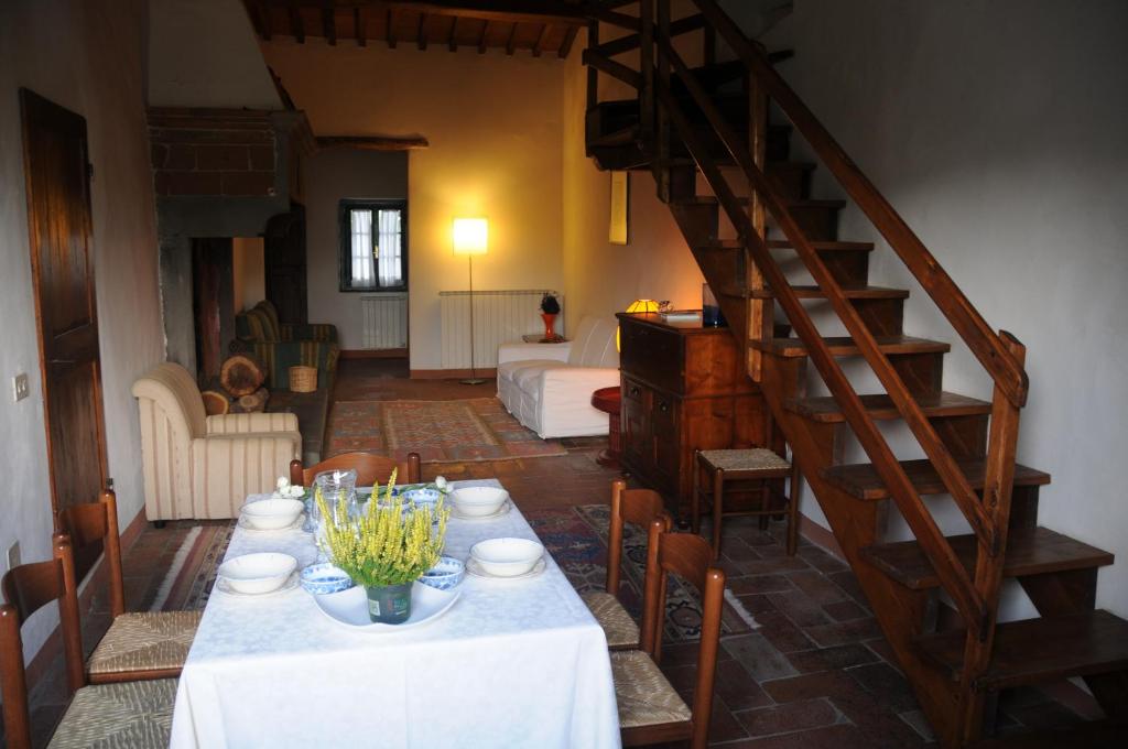 a living room with a table and a staircase at Casa Marina in Greve in Chianti