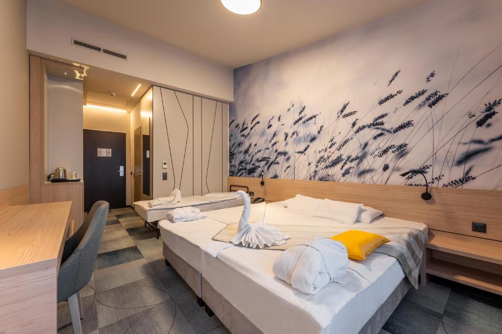 Postel nebo postele na pokoji v ubytování Globall Hotel