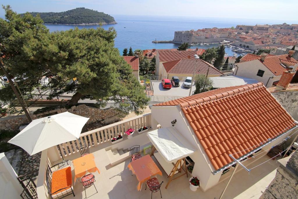a view of a house with an umbrella and chairs at Rooms&Studios Rina in Dubrovnik