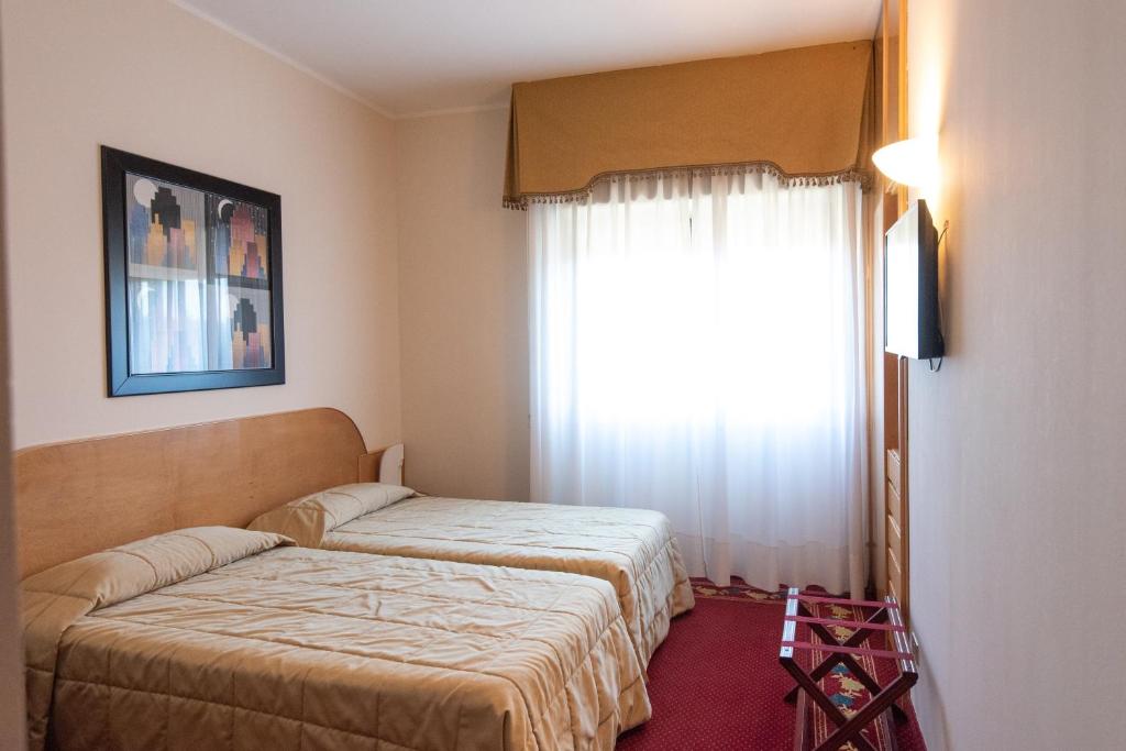 Łóżko lub łóżka w pokoju w obiekcie Hotel Castello Artemide Congressi