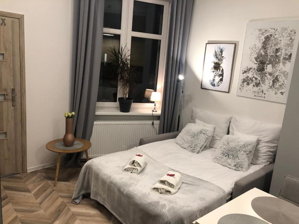 a small room with a bed and a window at Apartment Katowice Center in Katowice
