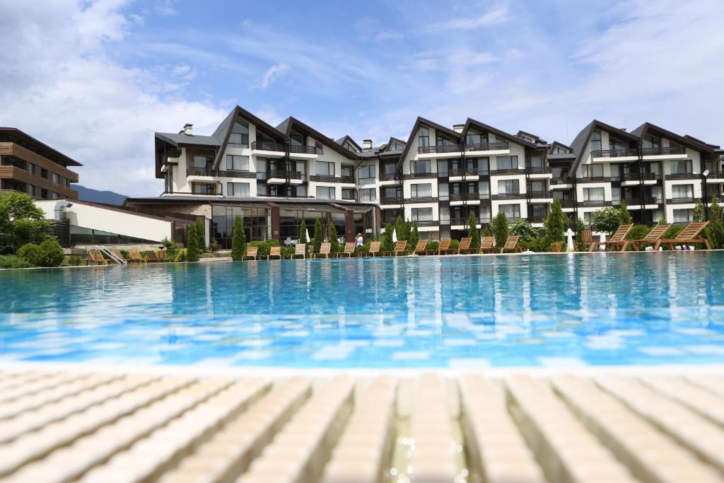 a large swimming pool in front of a building at Aspen Golf and Ski Resort in Bansko