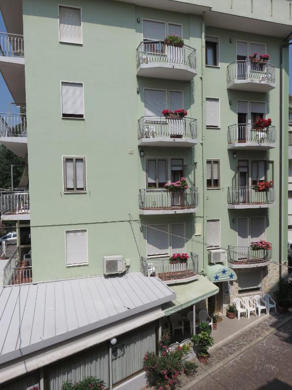 an apartment building with flowers on the balconies at Stella del Mare in Sottomarina
