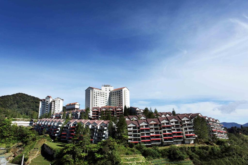 un groupe de bâtiments sur une colline plantée d'arbres dans l'établissement Copthorne Cameron Highlands, à Cameron Highlands