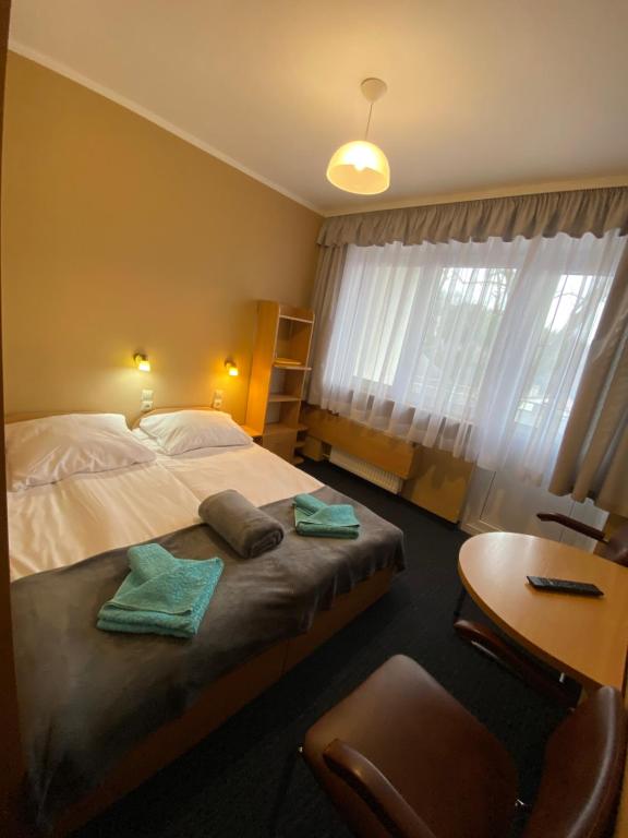 a bedroom with a bed and a desk and a table at OW DUET in Karpacz