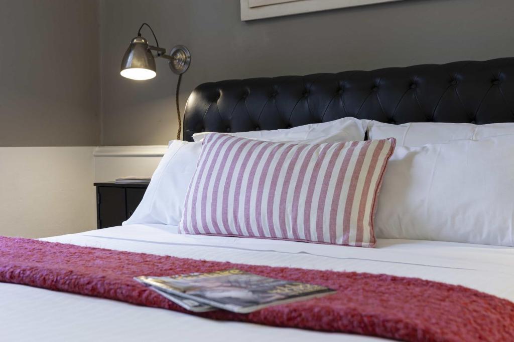 A bed or beds in a room at B&B Prestigia Rooms