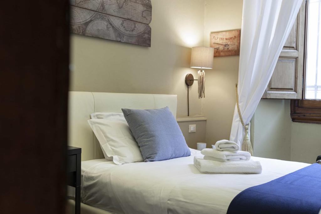 A bed or beds in a room at B&B Prestigia Rooms