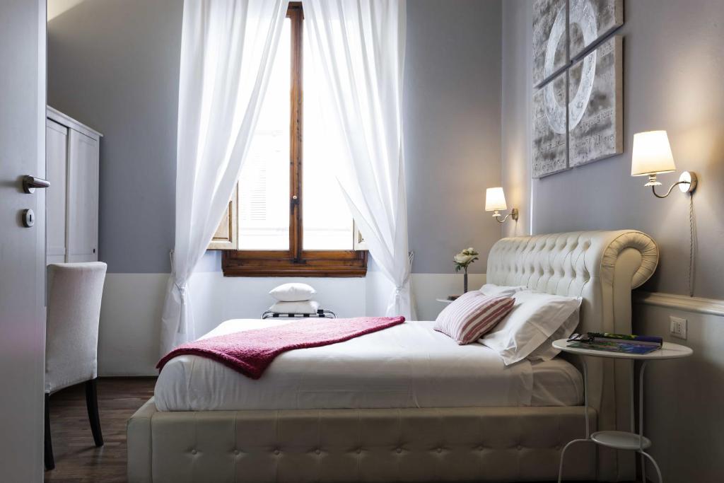A bed or beds in a room at B&B Prestigia Rooms