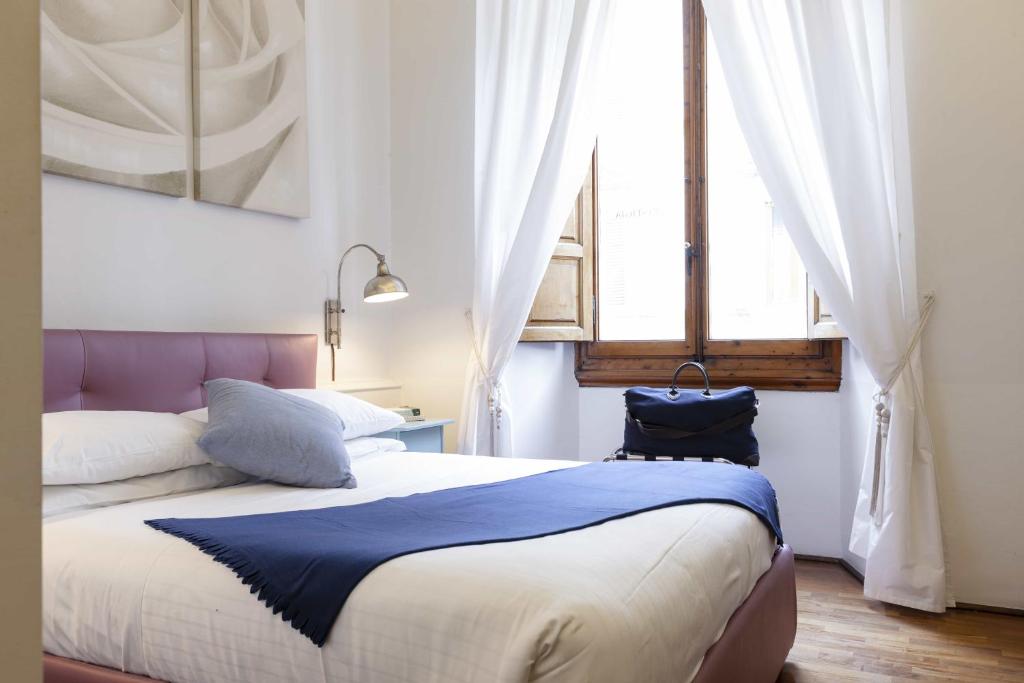 A bed or beds in a room at B&B Prestigia Rooms
