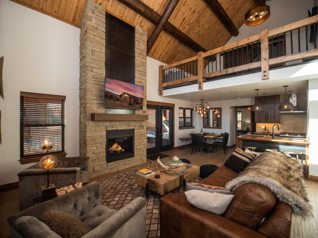 a living room with a couch and a fireplace at Estes Escape - Jacuzzi, Indoor Outdoor Fireplace, Perfect Location! in Estes Park