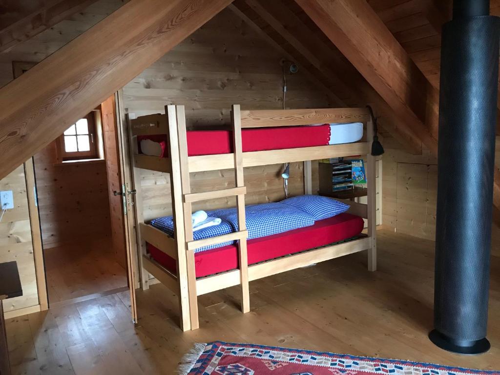 a bunk bed in the attic of a cabin at Chalet Charm in Molare