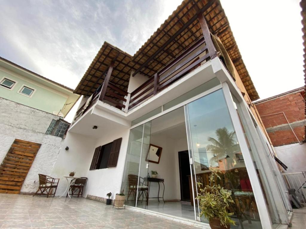a house with a large sliding glass door at Pousada do Foguete in Cabo Frio