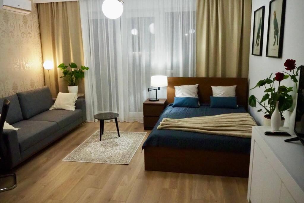 a bedroom with a bed and a couch at Studio nr 1 close to Medicover and Paley Institute in Warsaw