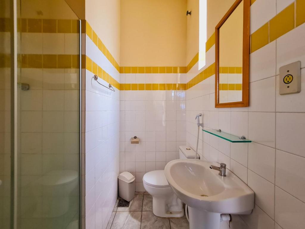 a bathroom with a sink and a toilet and a shower at Pousada Fagundes Varela in Niterói