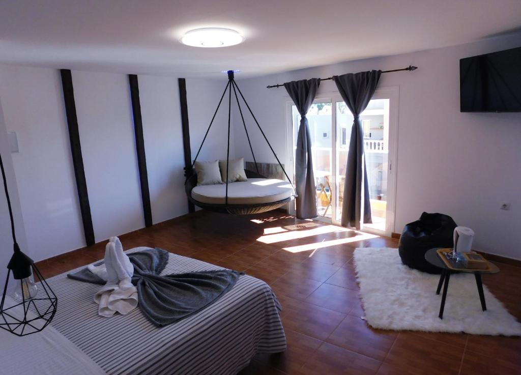 Chabela's Suites في Lajita: غرفة مع أرجوحة في منتصف غرفة النوم