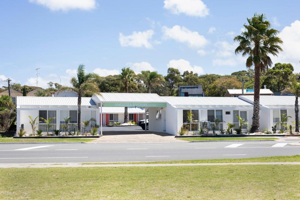 a white building with a road in front of it at Anglesea Riverside Motel in Anglesea