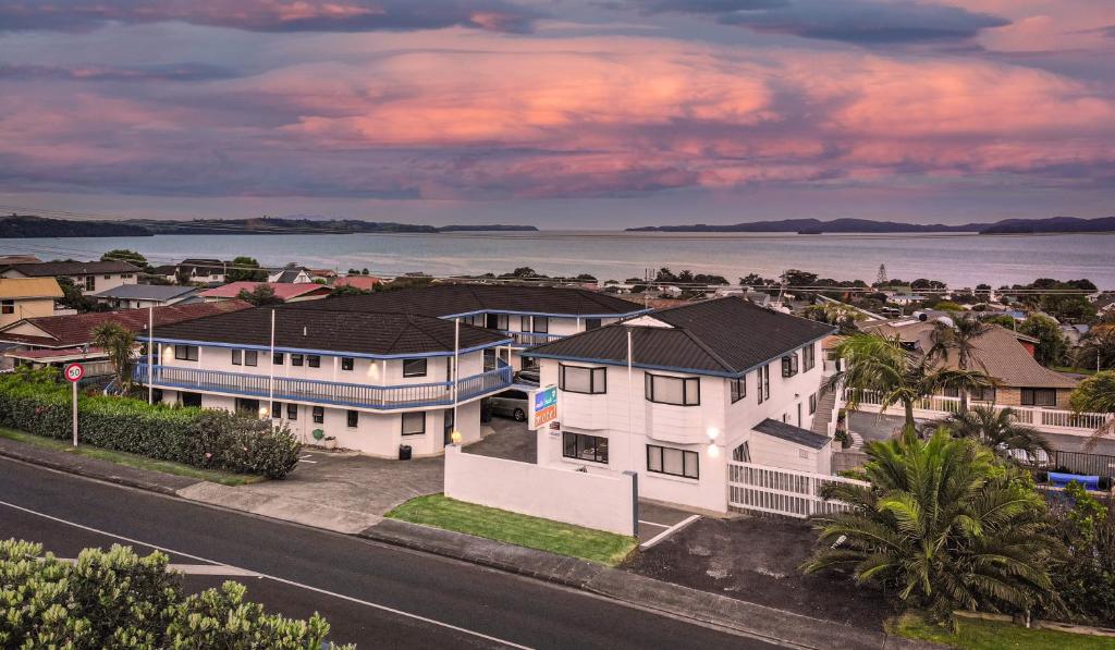 an aerial view of a house with the ocean in the background at Snells Beach Motel in Snells Beach