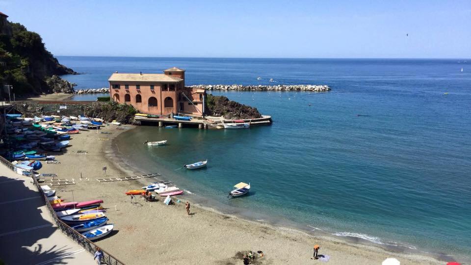a beach with a building and boats in the water at Villa La Pietra - Luxury location in Levanto, 5 Terre in Levanto