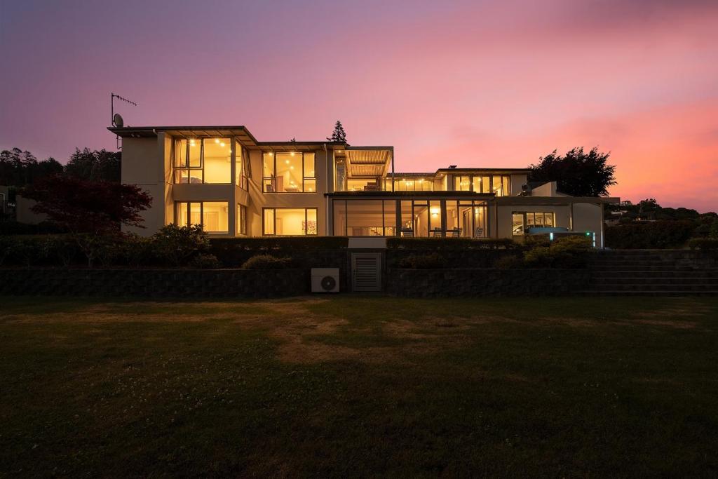 a large house at dusk with the lights on at OMAIO - Taupo in Taupo