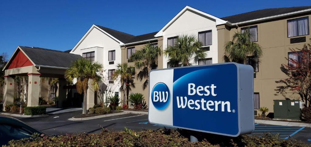 a best western sign in front of a building at Best Western Magnolia Inn and Suites in Ladson